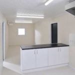 Internior view showing kitchen area of large 32ft site cabin