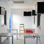 Interior of container office with TV and aircon units