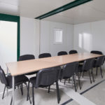 Conference room table within a linked flat pack office