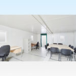 Interior of large flat pack cabin with office furniture