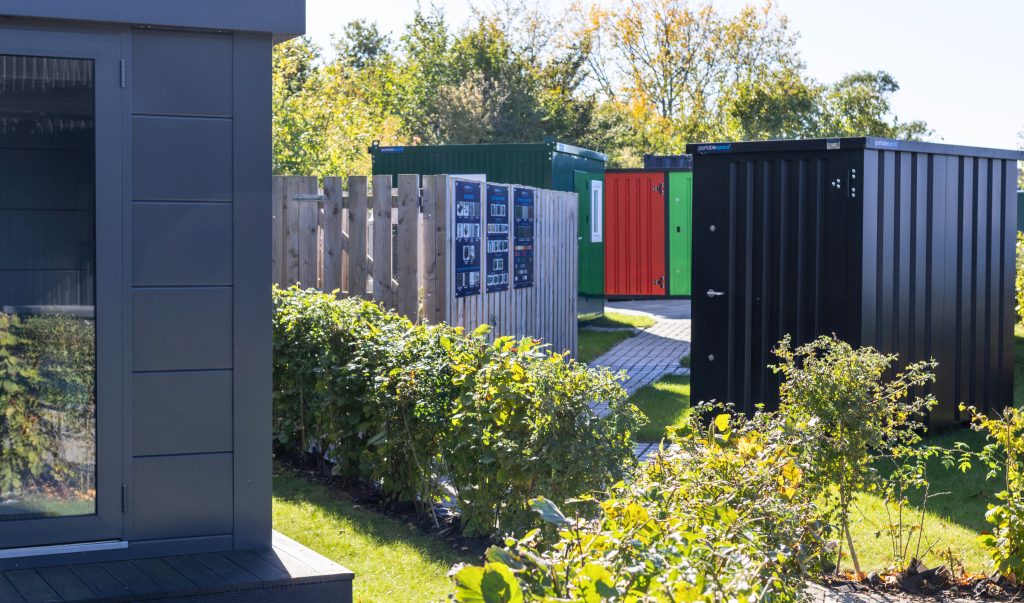Portable Space's flatpack show area including Como Garden Room, Flatpack Kiosk, Flatpack Garden Store, Flatpack Storage Container, and Flatpack Cabin